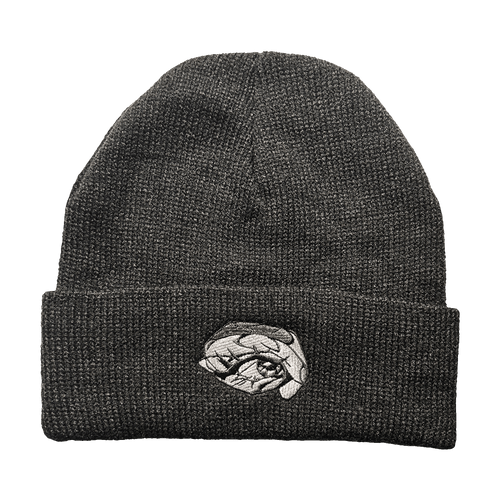 Dark black knit toque with a detailed grayscale embroidered eye patch on the cuff
